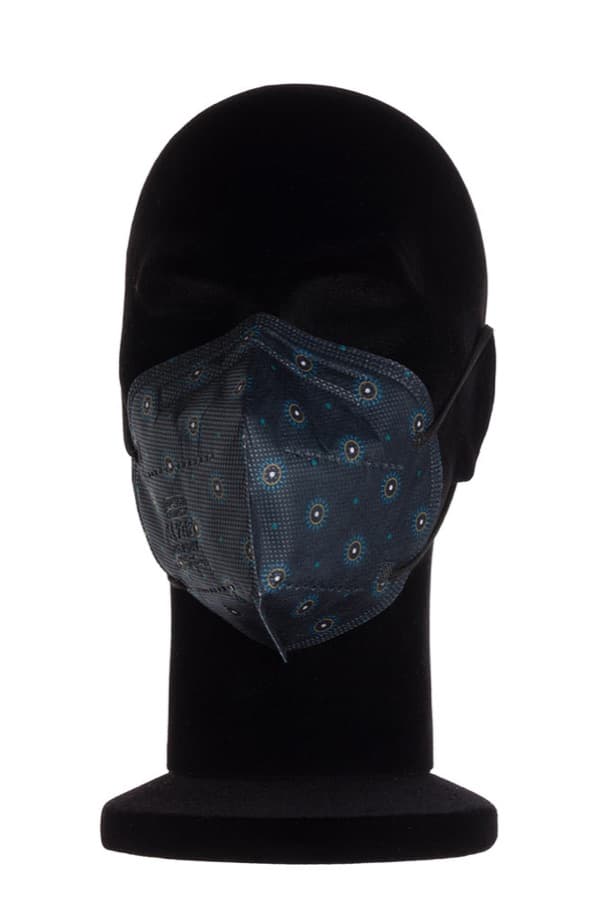 A midnight blue My Mask Pro FFP2 printed with small suns, on a black mannequin head.