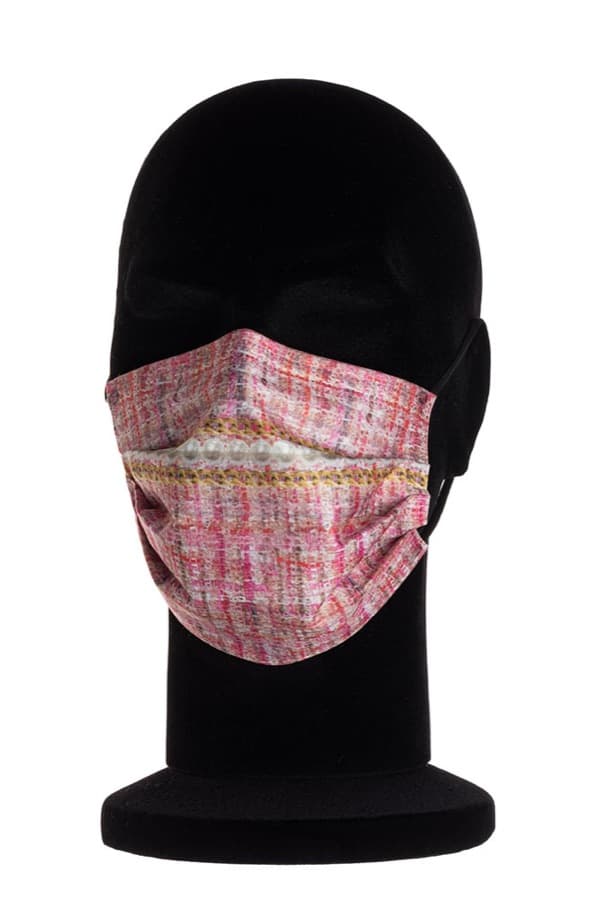 A Silky Touch surgical mask in pink tweed with a band of pearls and gold chain, on a black mannequin head.